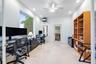 Recessed lighting, ceiling fan, built-in shelving, glass-paned door, and large window