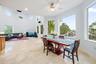 Expansive living area with high ceilings, recessed lighting, and large format tile flooring