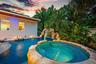 Resort-style pool with integrated spa and rock waterfall feature