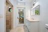 White vanity with integrated sink, granite countertop, and chrome faucet