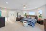 Recessed lighting, ceiling fan, carpeting, multiple windows, and double doors