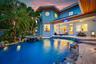 Expansive outdoor living area featuring a large swimming pool, integrated hot tub, and a spacious covered patio
