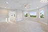 Expansive room with neutral carpet flooring, recessed lighting, and a ceiling fan