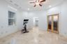 Travertine flooring, recessed lighting, and a ceiling fan with light fixture