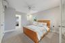 Wall-mounted split system, ceiling fan, recessed lighting, and carpeted flooring