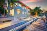 Multi-level concrete patio with integrated lighting and a wood-planked dock