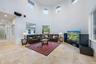 Vaulted ceilings with circular and rectangular windows, recessed lighting, tile flooring, and built-in speakers