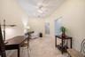 Vaulted ceiling with a ceiling fan, recessed lighting, and tile flooring