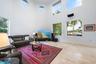 Soaring ceilings with upper-level rectangular and circular windows