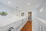 Wood-finish flooring, recessed lighting, and a distinctive oval window