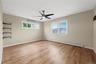 Large primary bedroom with large closets and windows making a bright space