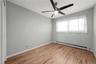 3rd. Bedroom with large window for natural lighting and ceiling fan