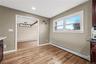 Wood-finish flooring, recessed lighting, and a window with trim