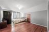 Hardwood flooring, painted walls, and ceiling-mounted light fixture