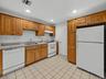 Generous cabinetry, full-size appliances and additional storage offered in the lower-level summer kitchen