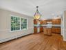 The spacious dining area is filled with natural light and offers ample room for everyday meals or occasional gatherings.