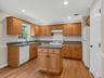 The thoughtfully designed kitchen offers abundant cabinetry, generous prep space, a center island, and a functional layout that makes everyday cooking