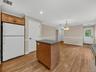 A convenient pantry provides additional storage, while the open layout creates an easy connection between the kitchen and spacious dining area.