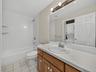A full bath with second laundry area adds to the convenience of the lower level, with a stackable washer and dryer dedicated to this level of the home