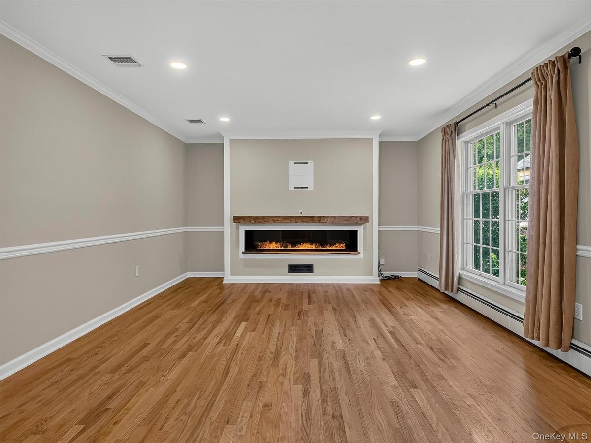 Designed for both comfort and style, the expansive living area features elegant architectural details, recessed lighting, and a striking custom center