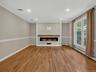 Designed for both comfort and style, the expansive living area features elegant architectural details, recessed lighting, and a striking custom center