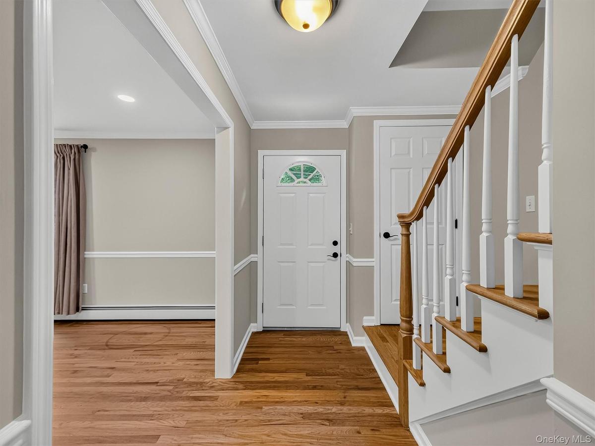 A functional entry with a convenient coat closet is complemented by hardwood floors and custom trim work, setting the tone for the quality found throu