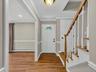 A functional entry with a convenient coat closet is complemented by hardwood floors and custom trim work, setting the tone for the quality found throu