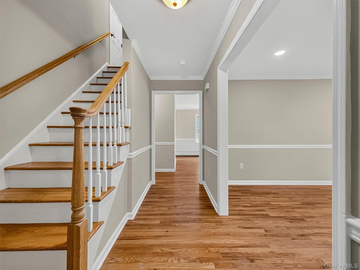 The welcoming foyer introduces the home's timeless character with hardwood flooring, beautifully crafted trim work, and quality finishes that continue