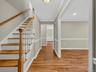 The welcoming foyer introduces the home's timeless character with hardwood flooring, beautifully crafted trim work, and quality finishes that continue