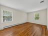 Generous proportions continue in the third bedroom, with hardwood floors and natural light from two exposures creating a bright, comfortable retreat.