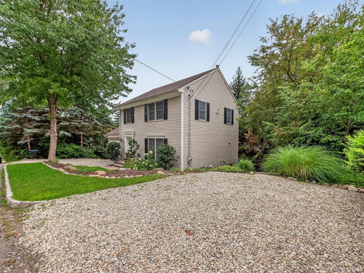 A secondary driveway provides additional parking and convenient private access to the finished lower level, adding flexibility for everyday living.