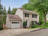 The attached garage, generous parking, and thoughtfully maintained exterior offer everyday convenience with lasting appeal.