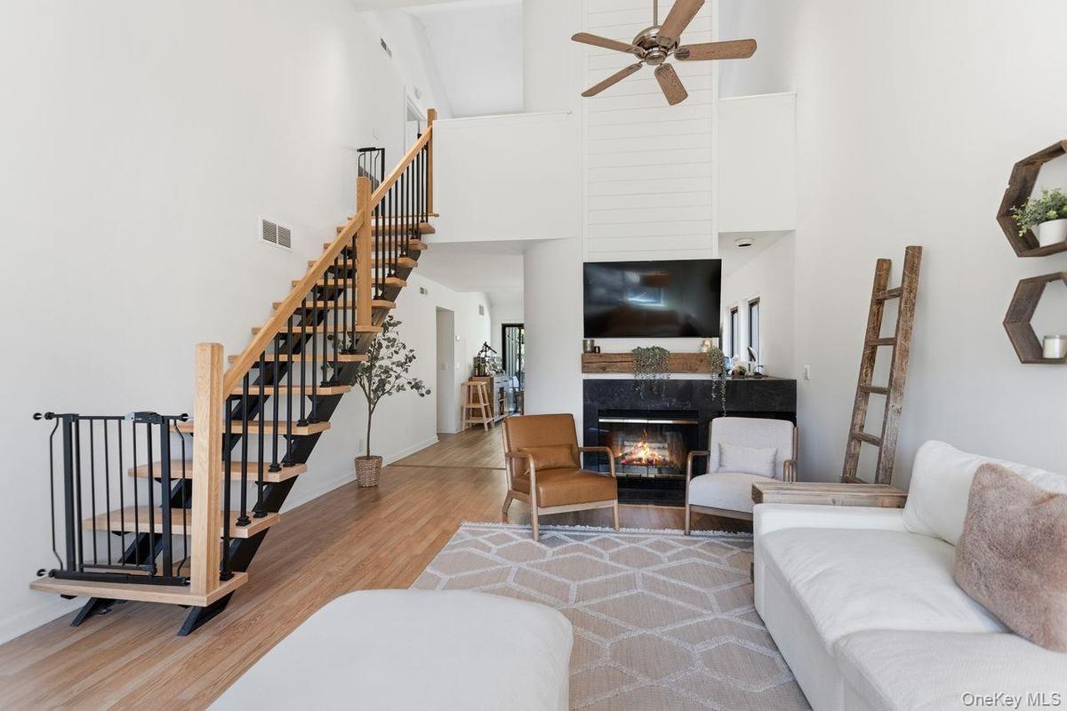 Living room with fireplace and brand new stairs to loft and office.