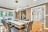 Dining room featuring light wood-style flooring, a chandelier, crown molding, baseboards, and recessed lighting