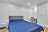 Bedroom featuring ornamental molding, light wood-style flooring, recessed lighting, and baseboards