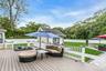 Deck featuring an outdoor living space, view of scattered trees, and an outbuilding
