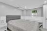 Bedroom with recessed lighting and a baseboard heating unit