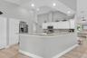 The spacious kitchen overlooks the family room & features a generous granite snack bar, creating a wonderful connection between cooking, casual dining