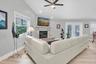 Expansive family room with generous proportions, easily accommodating a large seating arrangement while maintaining a comfortable, inviting atmosphere