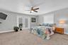 The spacious primary suite offers French doors opening to the rear deck, a private ensuite bath & a generous walk in closet; creating a comfortable & 