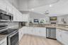 Light & bright kitchen offering abundant counter space & generous cabinetry for plenty of storage.