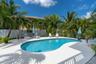 The expansive backyard offers a lush tropical setting, fully fenced for privacy & creating a peaceful retreat for relaxing & entertaining.