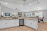 The kitchen has an abundance of natural light. Enjoy preparing meals while engaging with family and friends.