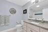 Spacious second bathroom featuring a tub & shower combination, granite countertop & classic porcelain sink.