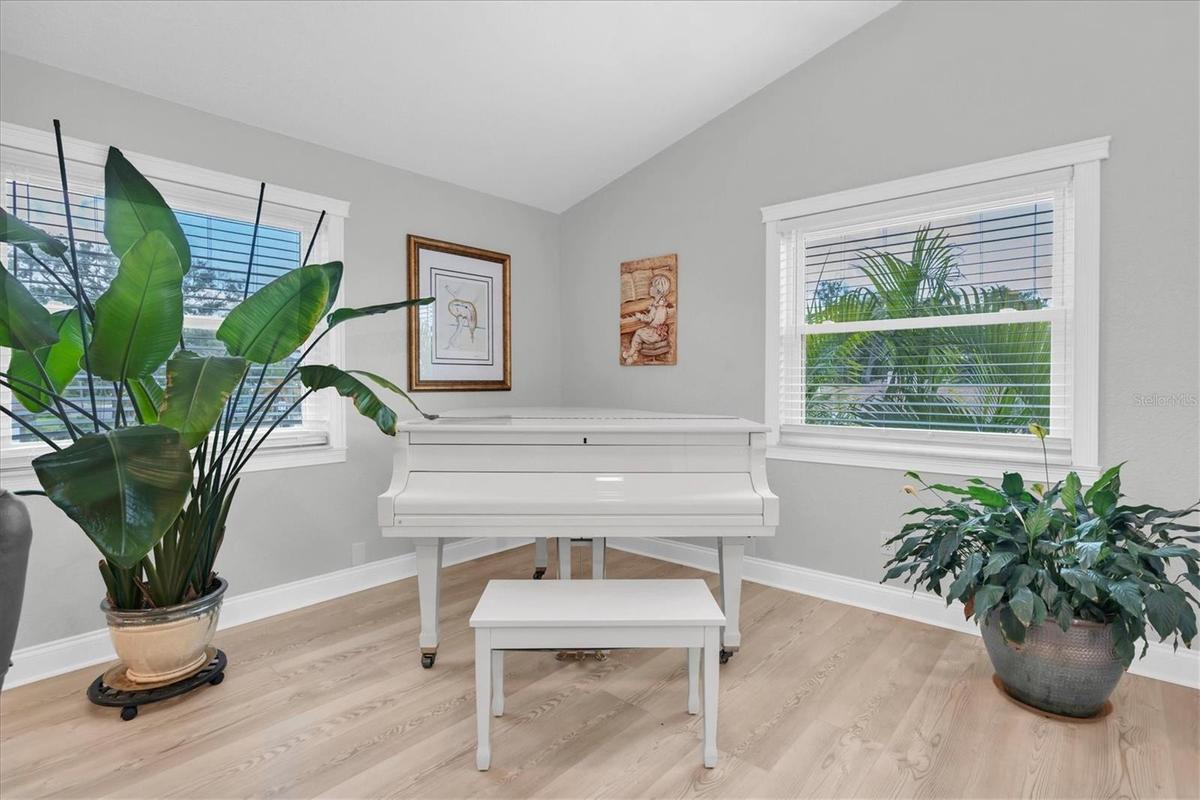 Expansive living room offering flexible space for both living and formal dining; the current owners have beautifully utilized the dining area for thei