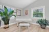 Expansive living room offering flexible space for both living and formal dining; the current owners have beautifully utilized the dining area for thei
