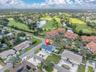 Aerial view overlooking the home, surrounding residences, and the beautiful Pasadena Yacht & Country Club golf course.
