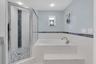 The primary ensuite bath features a deep jetted soaking tub, creating a relaxing, spa like retreat in the comfort of home.