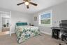 The generously sized second bedroom offers a warm & welcoming atmosphere, creating a comfortable retreat for rest & relaxation.
