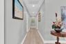 An wide hallway enhances the home’s spacious feel & provides a comfortable, open flow between the living areas & bedrooms.”